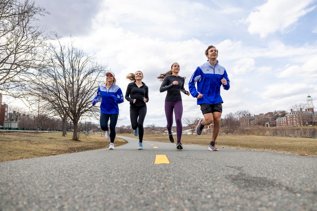 Bridget Kondrat, Maggie Chiappetta-Uberti, Brooke Stanford, and Andrew Athanasian run along the Charles River.