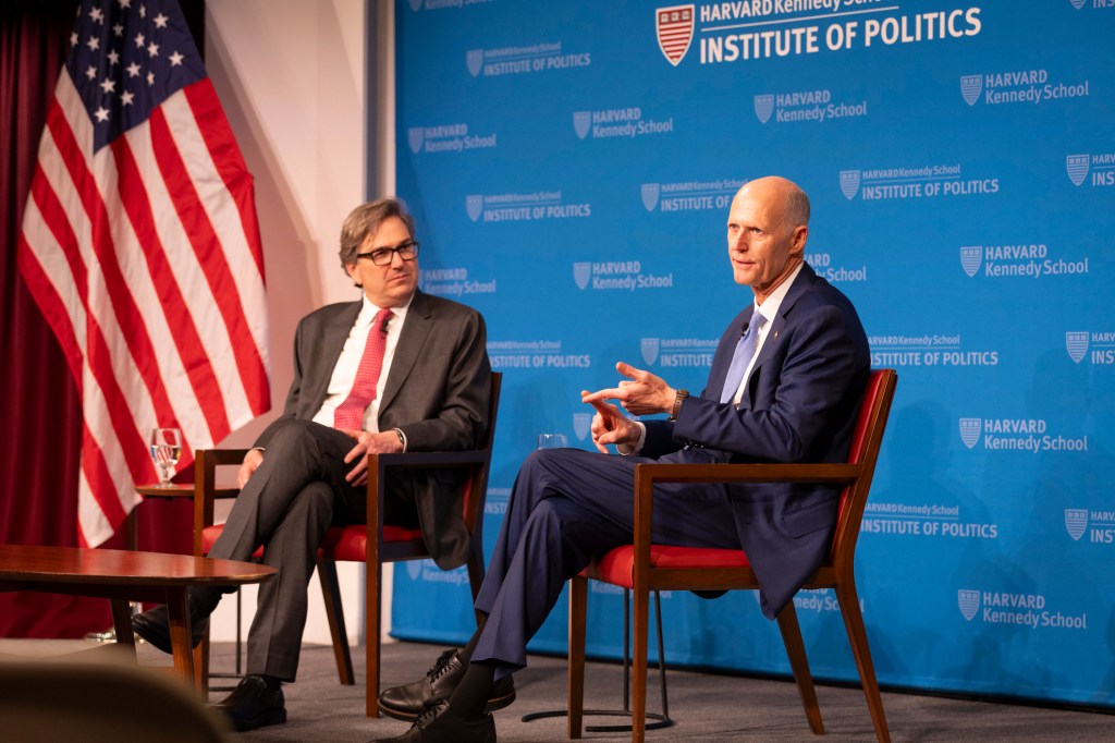 Jason Furman (left) and Rick Scott.