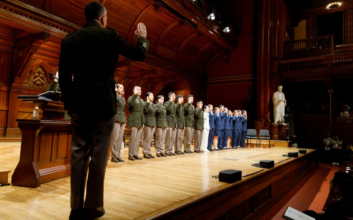 ROTC members take the oath of office during Harvard’s ROTC commissioning ceremony for the Class of 2025, in Sanders Theatre,