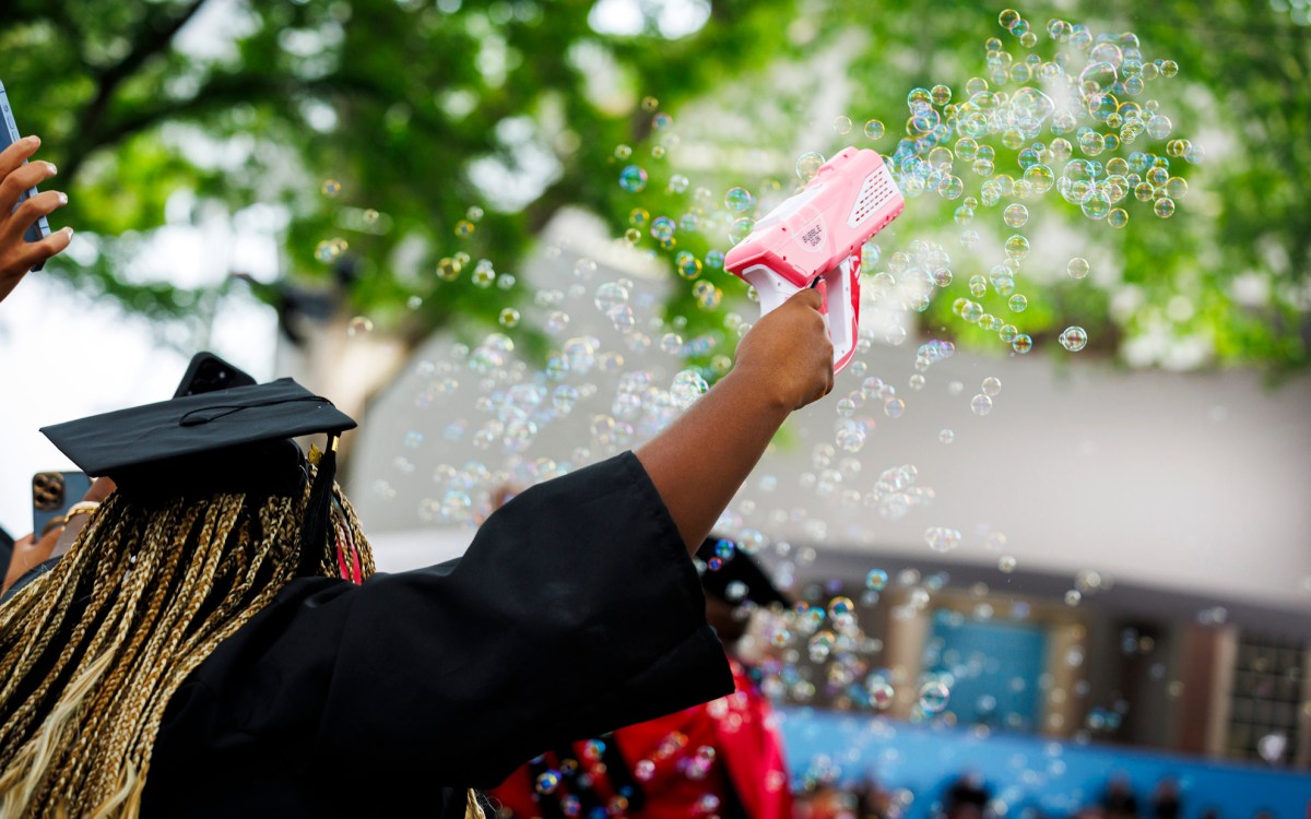 Tiffany Onyeiwu (pictured) blows bubbles during the ceremony.