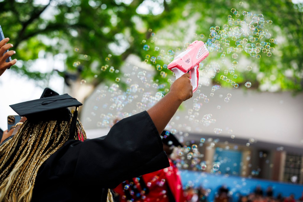 Tiffany Onyeiwu (pictured) blows bubbles during the ceremony.