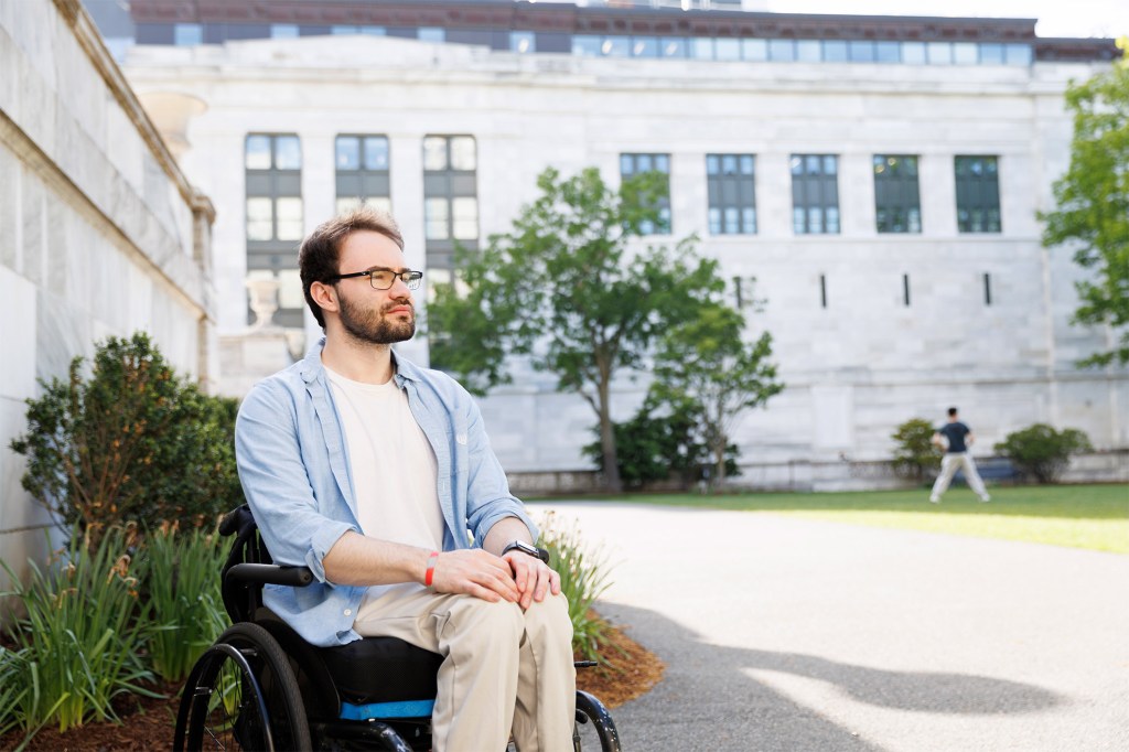 Jason Biundo sitting in a wheelchair in the Harvard Medical School Quad.
