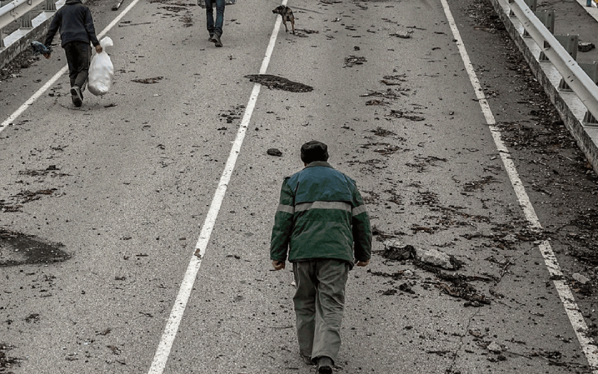 people walking over a bridge