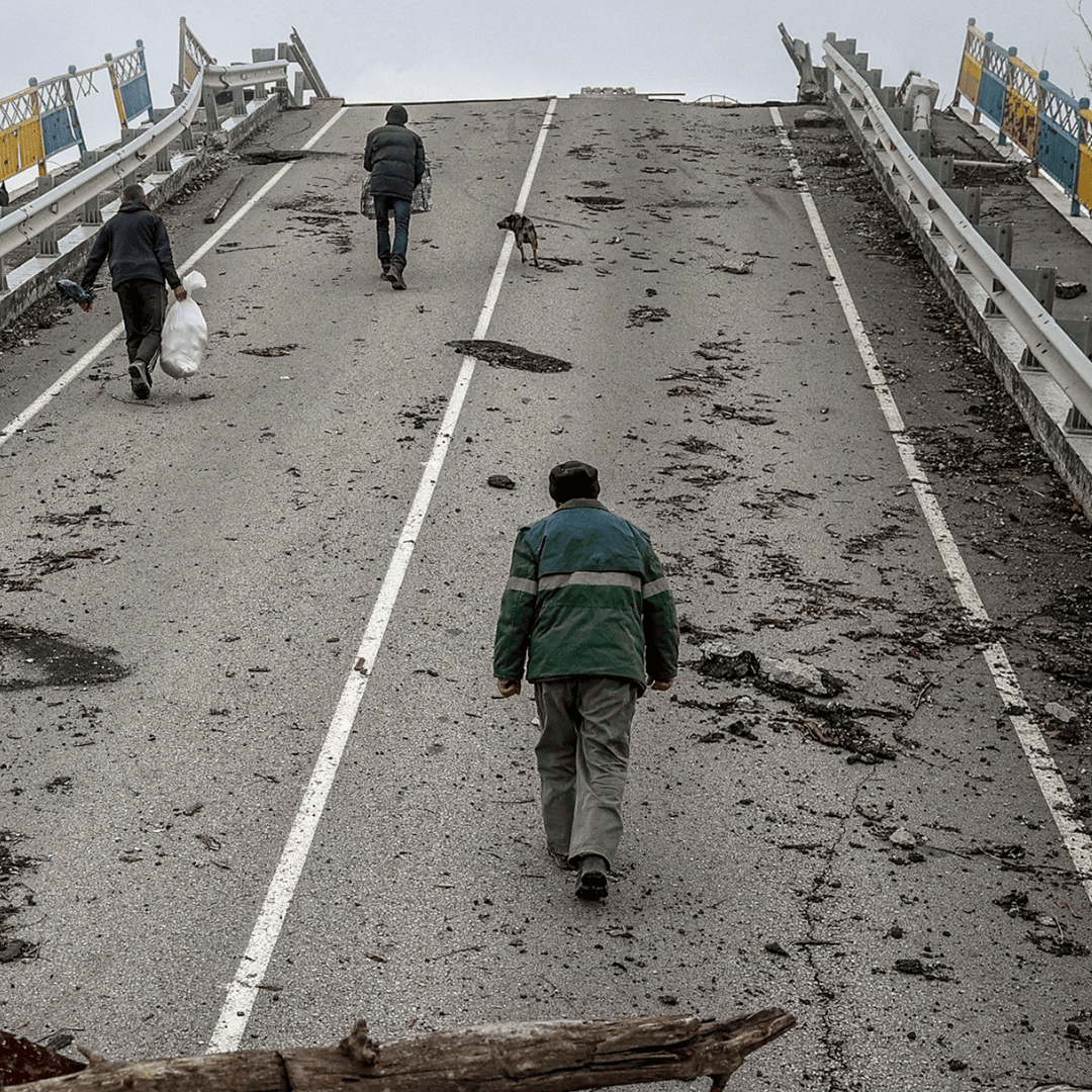 people walking over a bridge