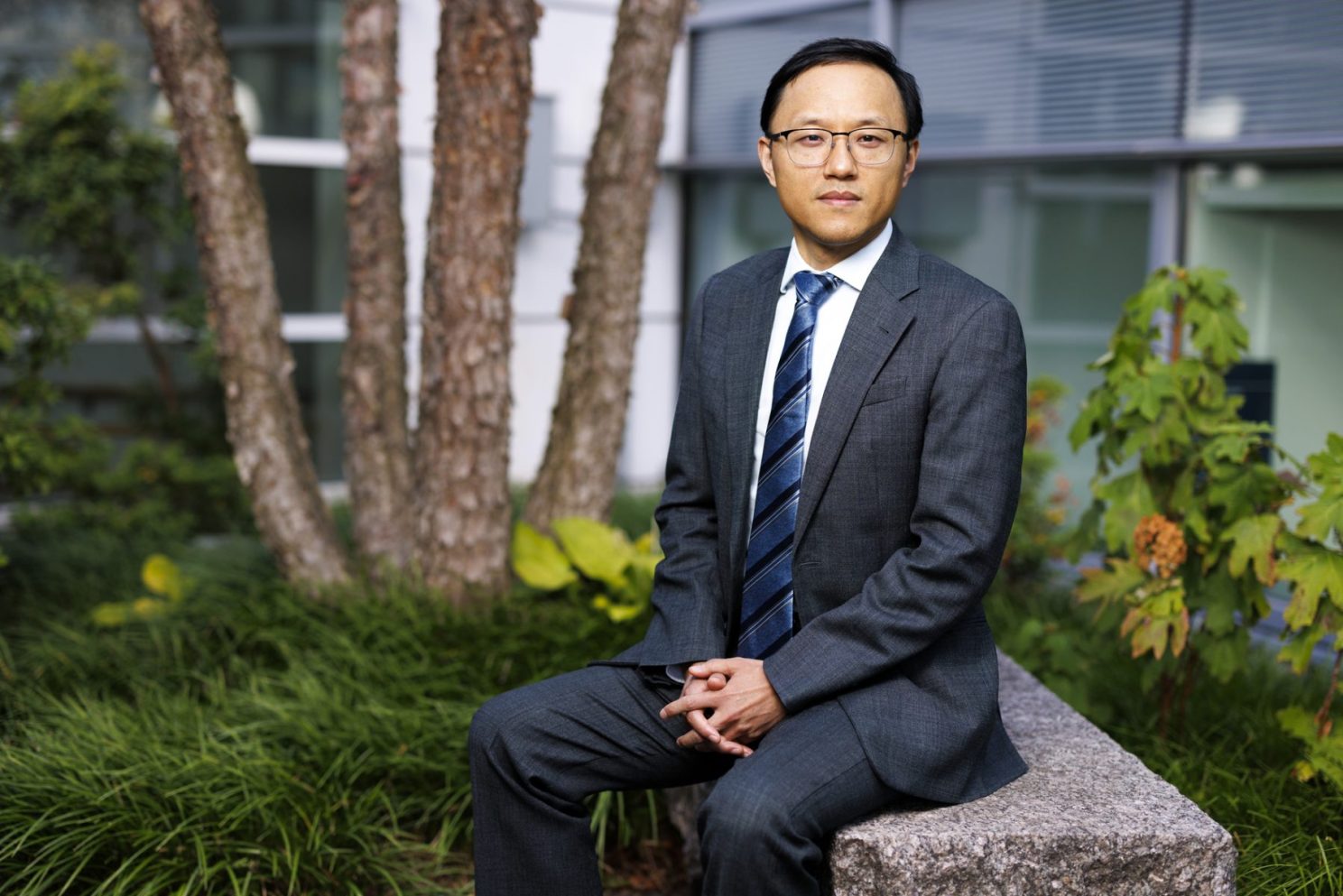 Wei Zhang sits outside.