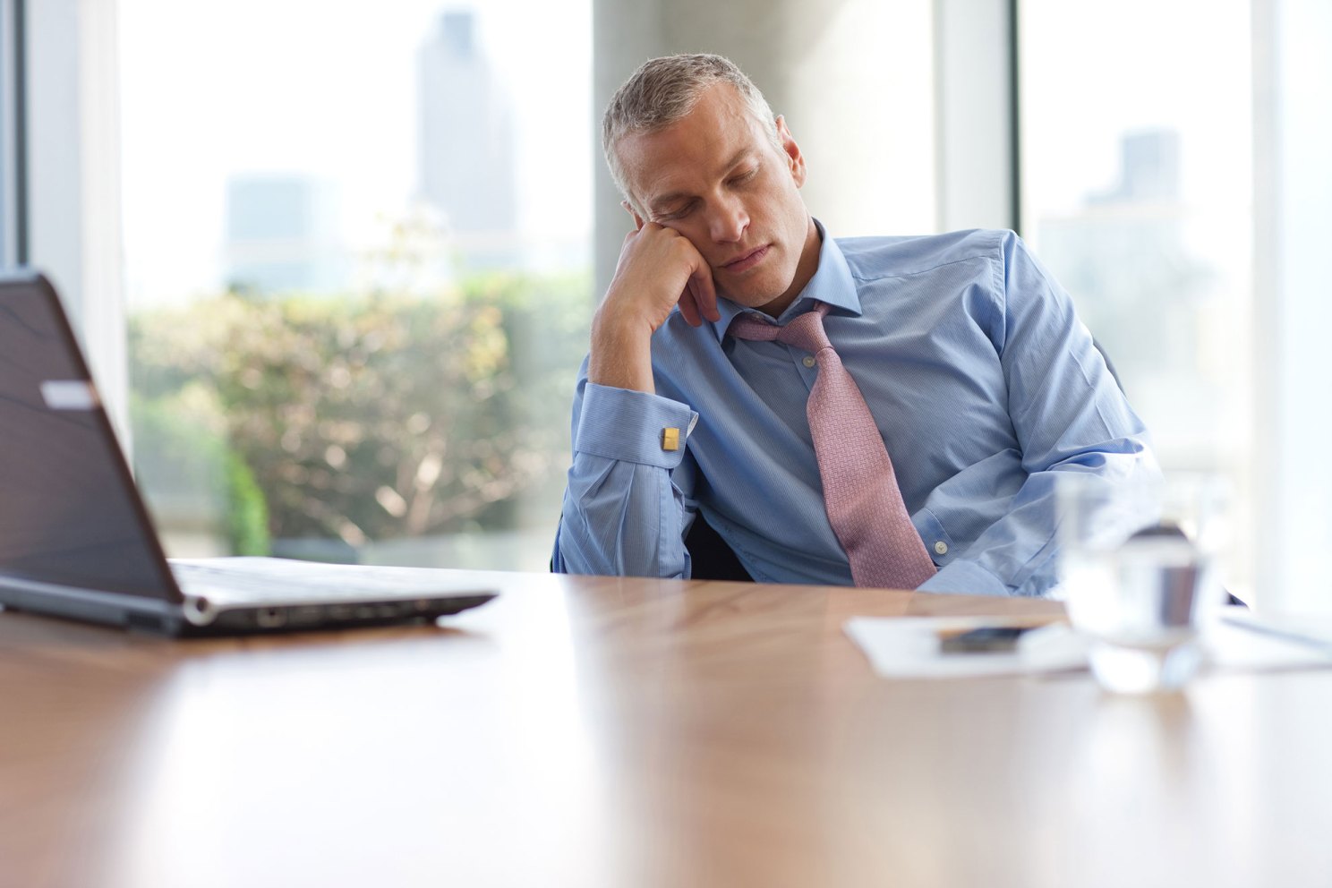 Man sleeping at desk.