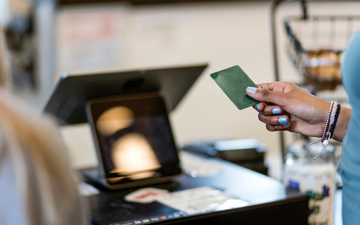A person pays for a purchase with a credit card. (Nathan Bilow/Getty Images)